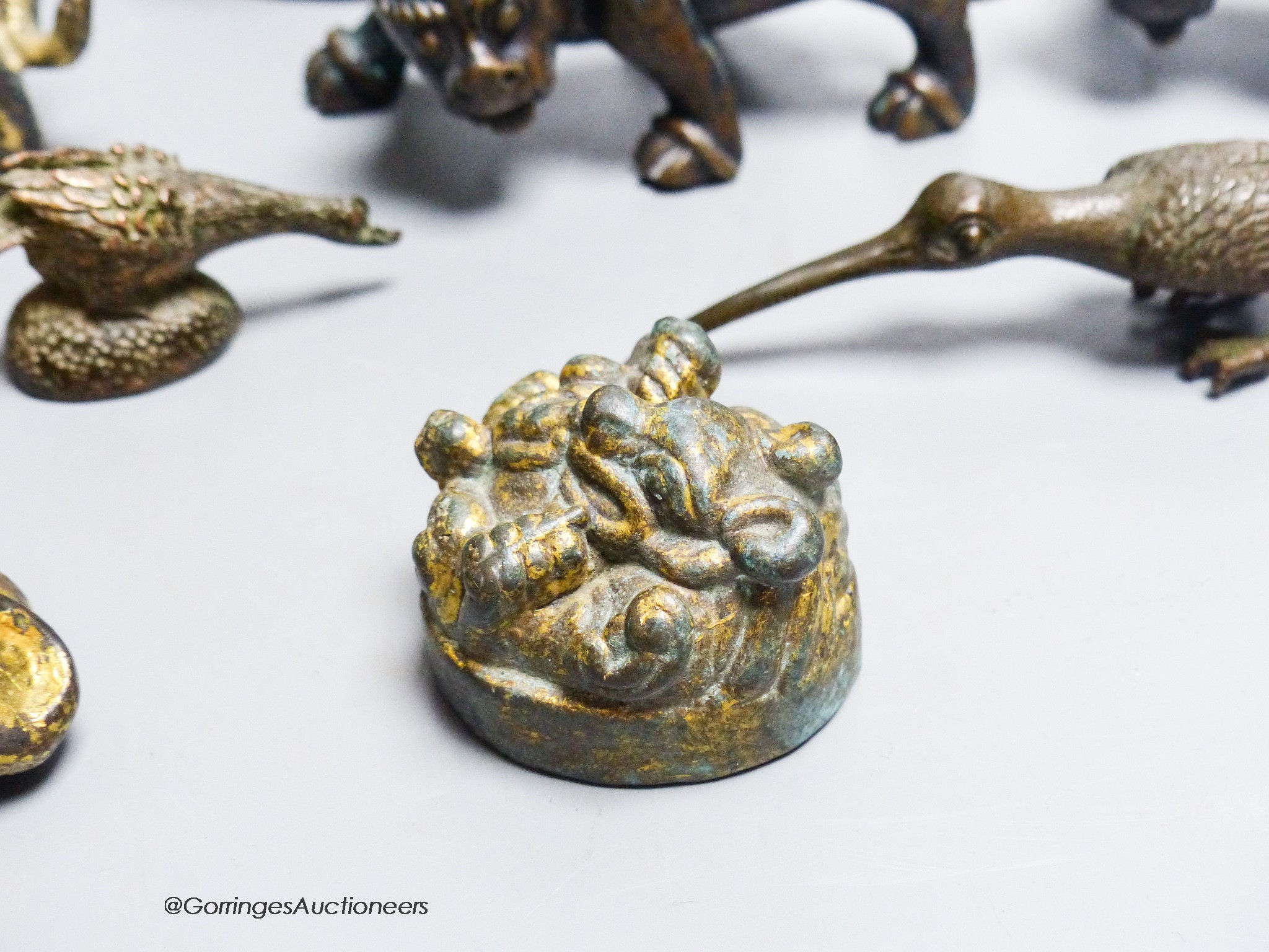 A group of nine Chinese and Oriental bronze figures to include five Han Dynasty style bronzes, tallest 12cm